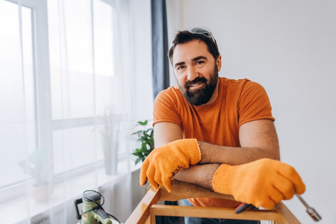 Smiling tradesperson in work gloves