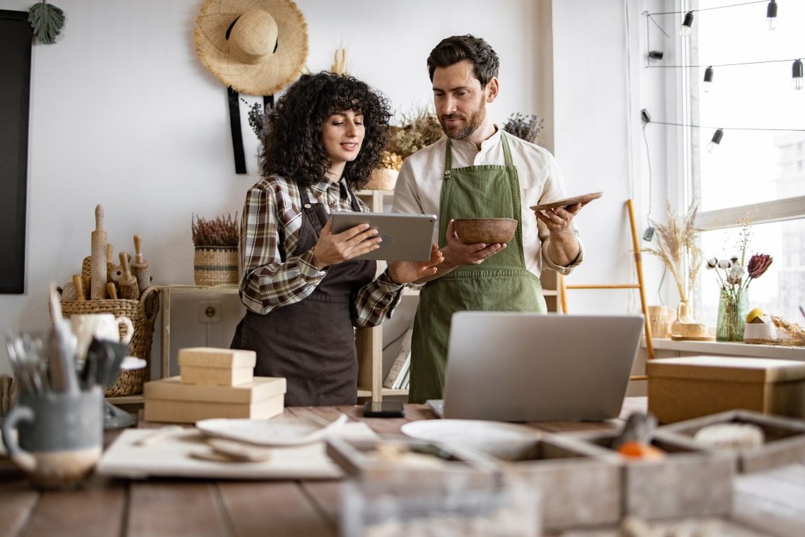 Two business owners planning together with a tablet